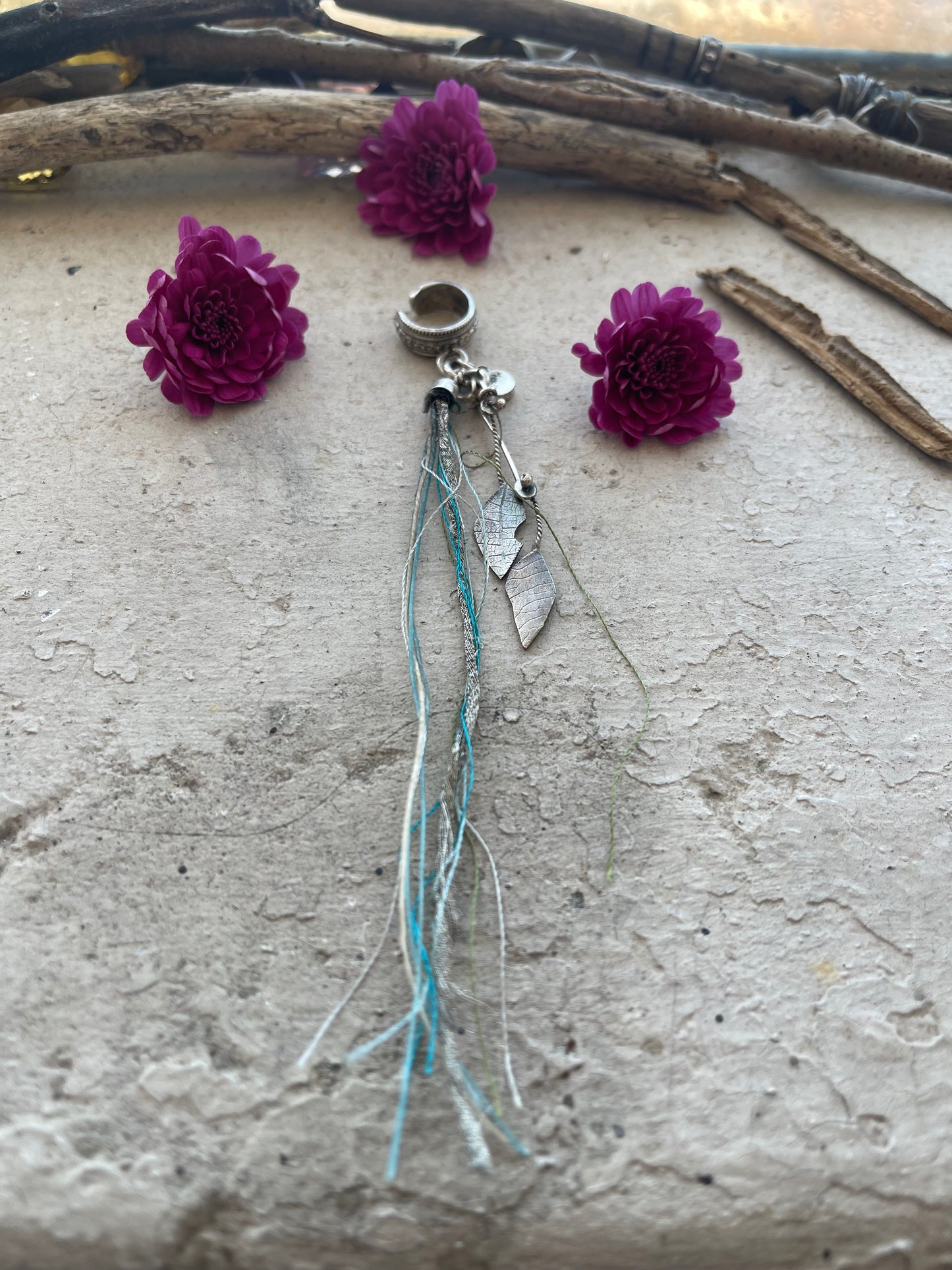 EARRING 98: STERLING SILVER CUFF WITH HAMMERED LEAVES AND BLUE STRING