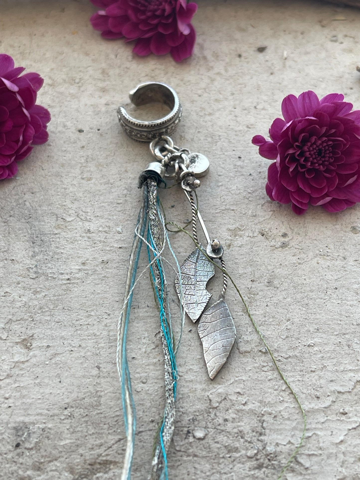 EARRING 98: STERLING SILVER CUFF WITH HAMMERED LEAVES AND BLUE STRING